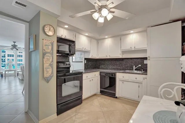 a bathroom with a granite countertop sink a toilet a mirror and shower