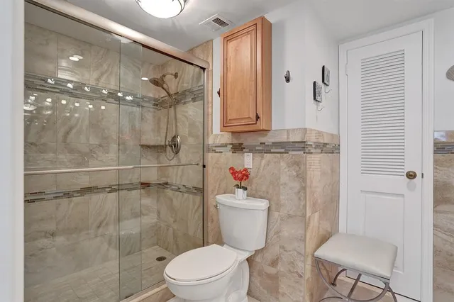 a bathroom with a toilet and a shower