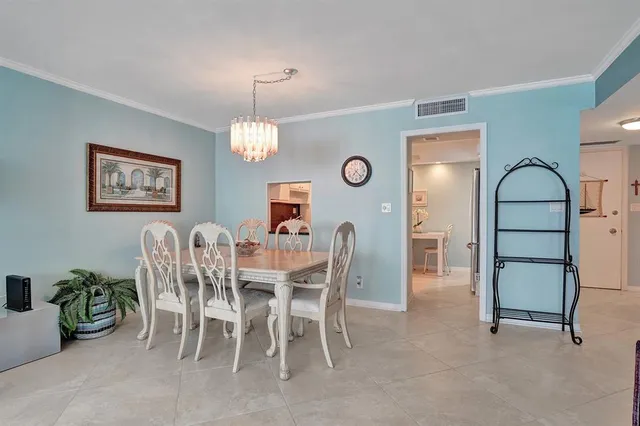 a view of a dining room with furniture and chandelier