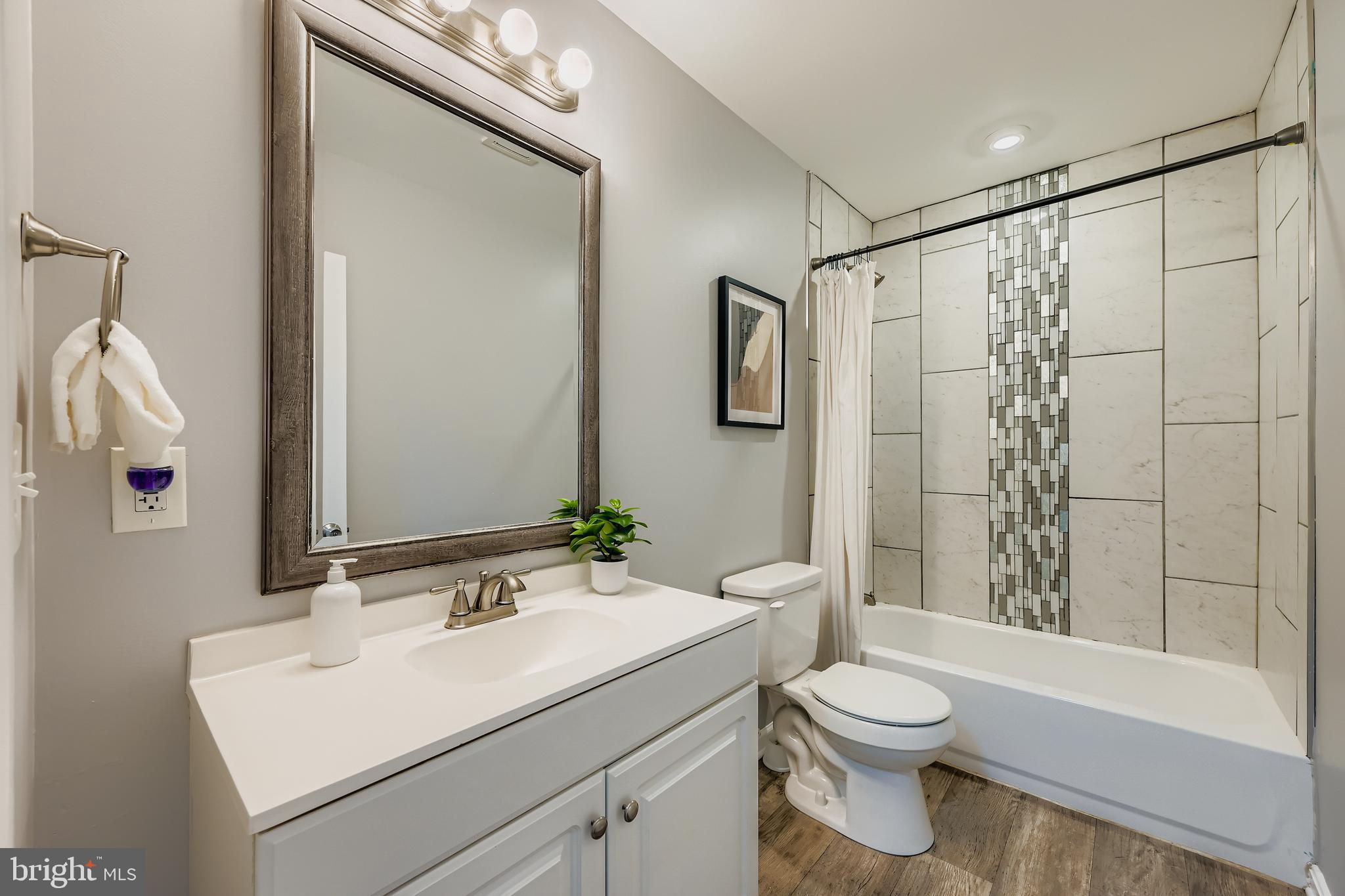 1229 North Point Road Dundalk, MD 21222 - Photo 13 of 28 a bathroom with a sink toilet and shower