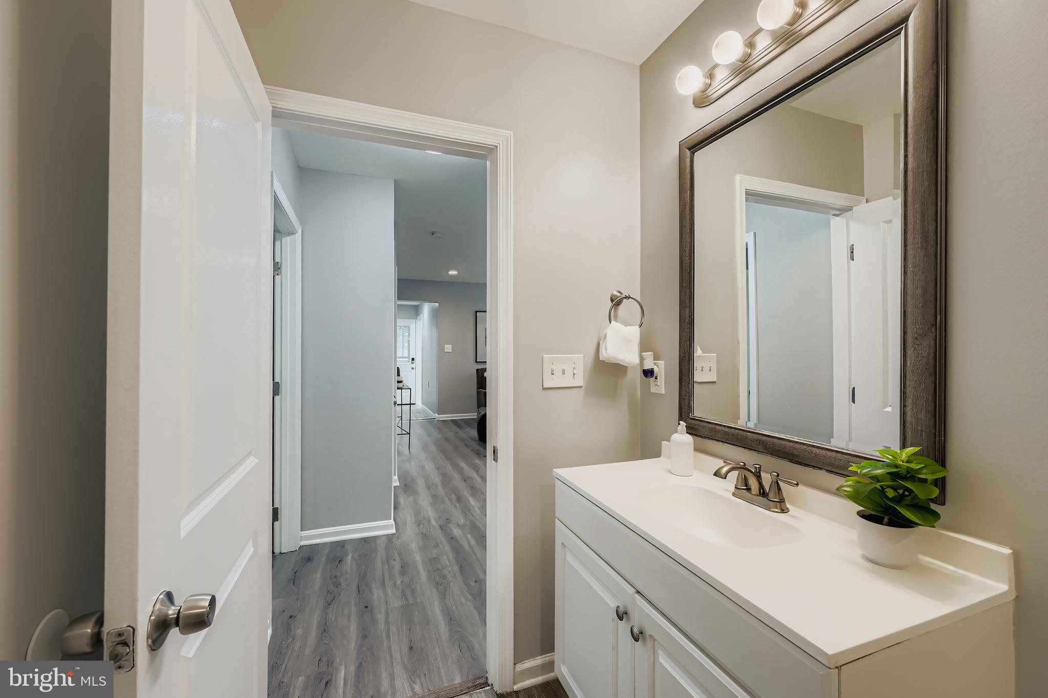 1229 North Point Road Dundalk, MD 21222 - Photo 14 of 28 a bathroom with a sink vanity granite and a mirror