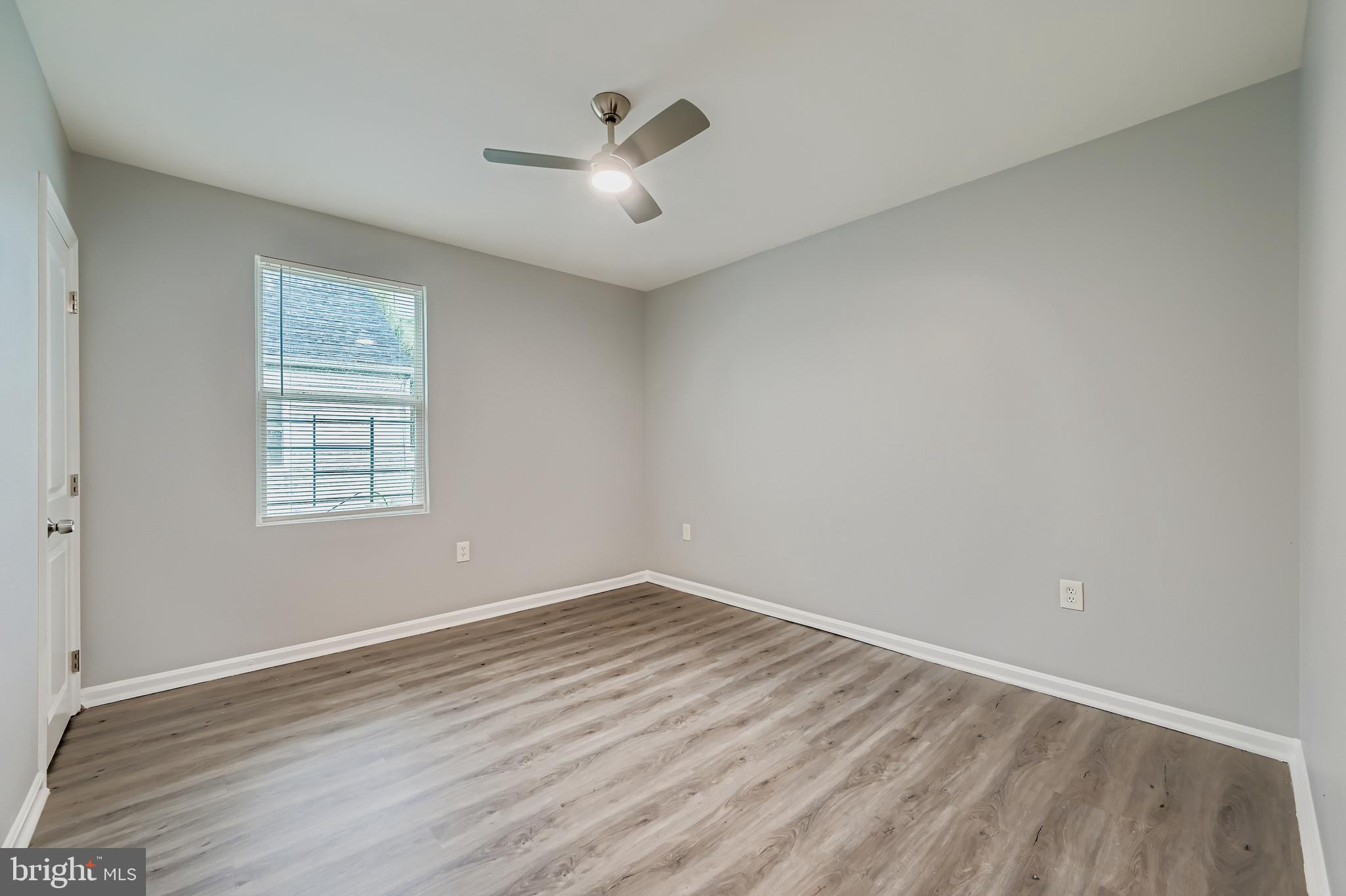 1229 North Point Road Dundalk, MD 21222 - Photo 15 of 28 wooden floor in an empty room with a window