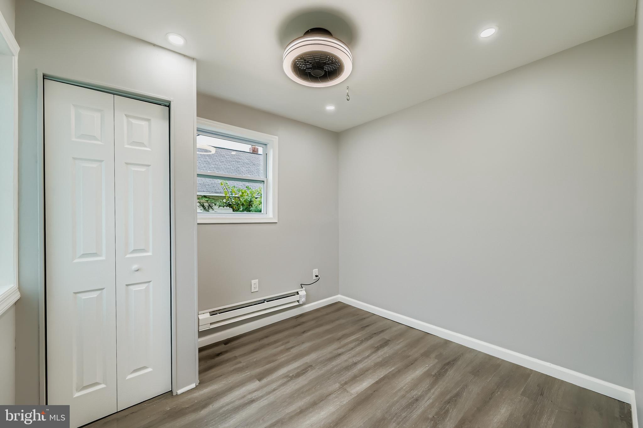 1229 North Point Road Dundalk, MD 21222 - Photo 16 of 28 an empty room with wooden floor and windows