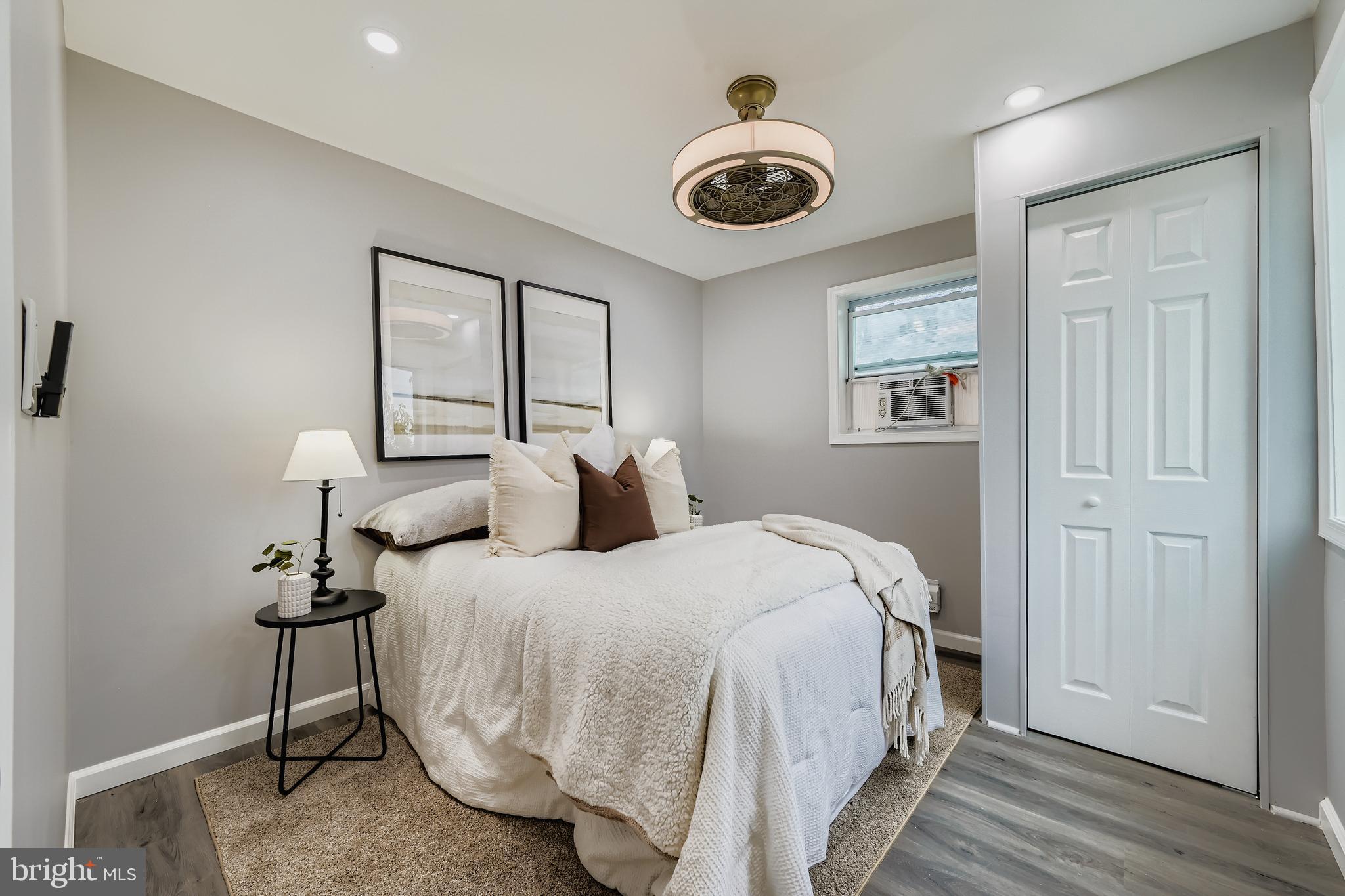 1229 North Point Road Dundalk, MD 21222 - Photo 17 of 28 a bedroom with bed and a chandelier