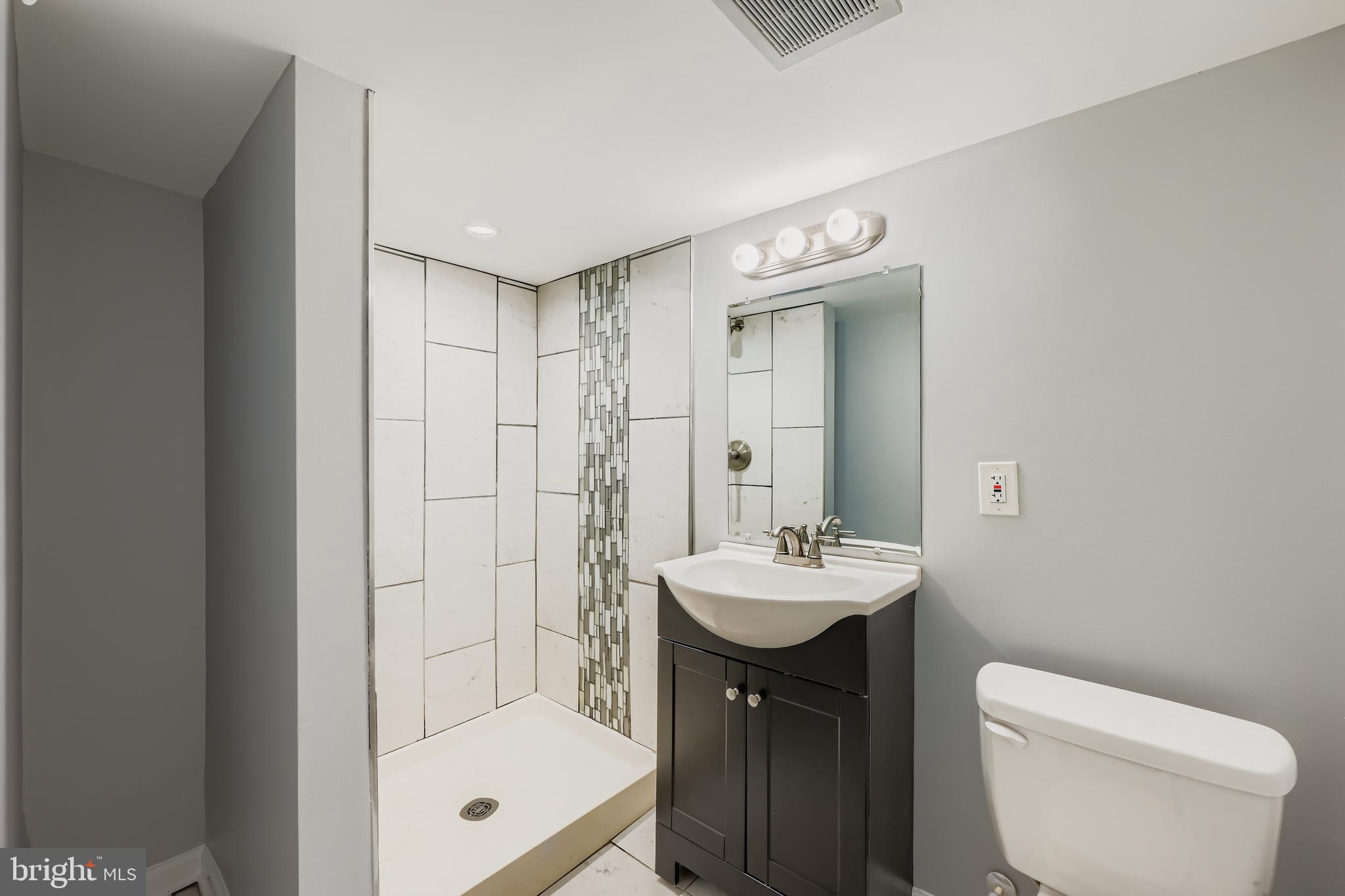 1229 North Point Road Dundalk, MD 21222 - Photo 20 of 28 a bathroom with a sink a toilet and shower