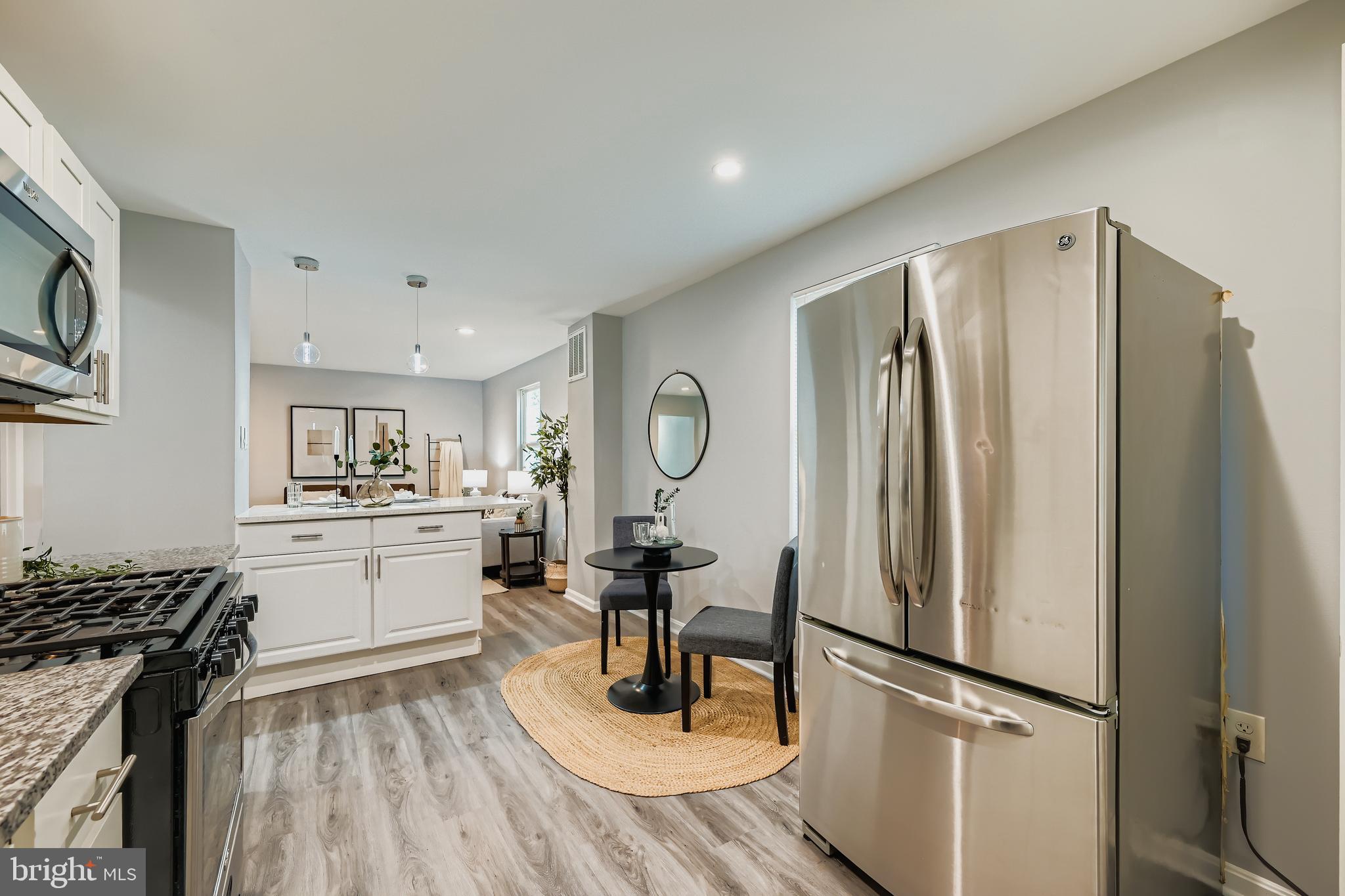 1229 North Point Road Dundalk, MD 21222 - Photo 7 of 28 a kitchen with stainless steel appliances a refrigerator stove and sink