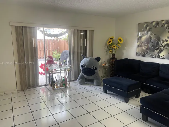 a living room with furniture and a kitchen view