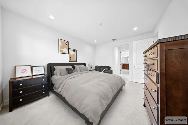 a spacious bedroom with two bed and a tv