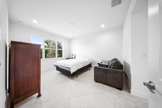 a bedroom with a bed and a couch