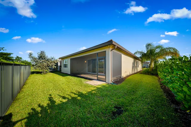 a view of a house with backyard and garden