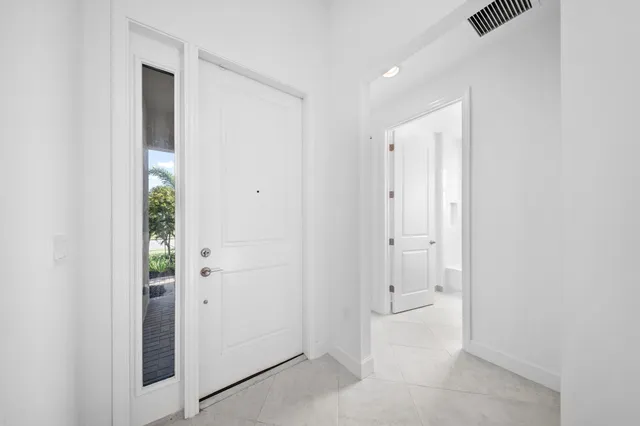 an empty room with window and entrance