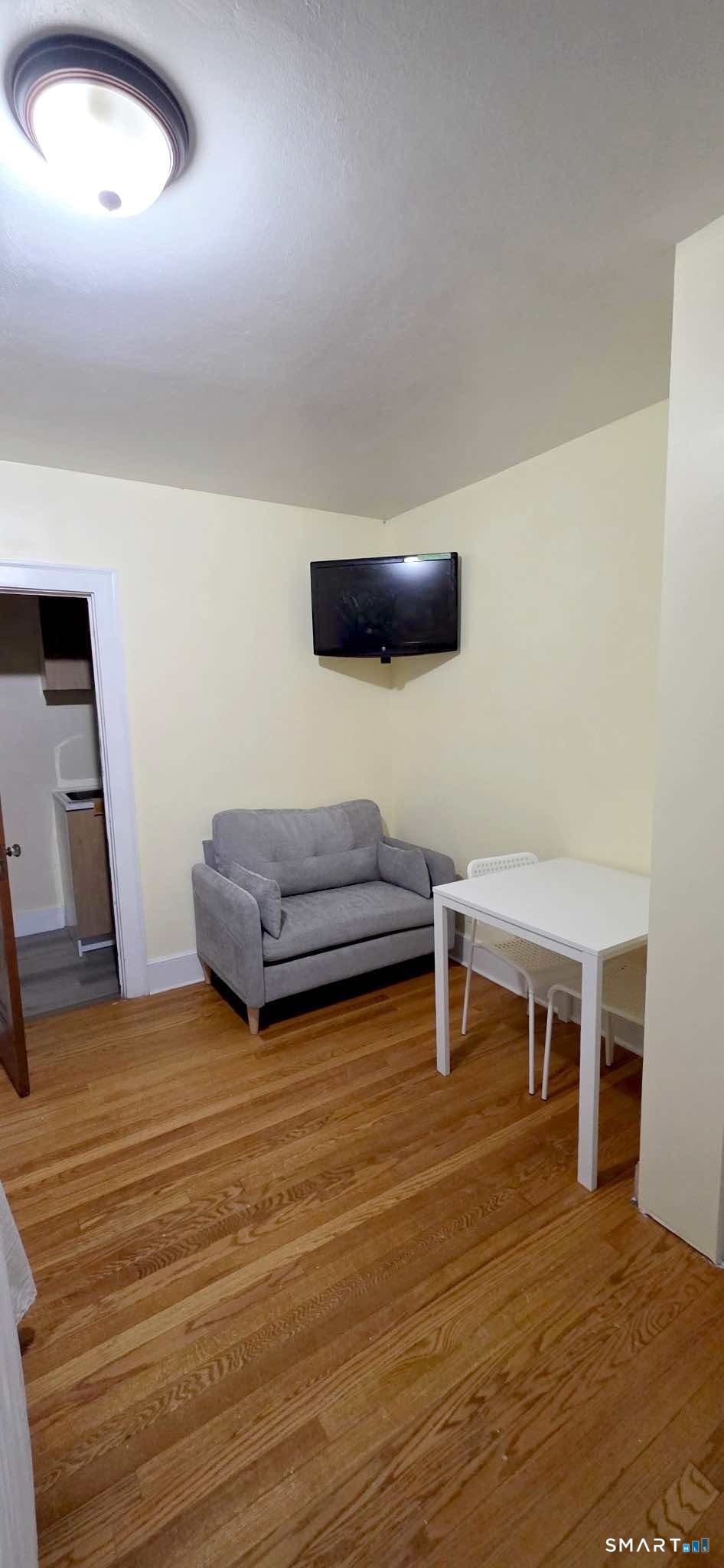 324 Curtis Street Meriden, CT 06450 - Photo 3 of 6 a living room with furniture and a wooden floor