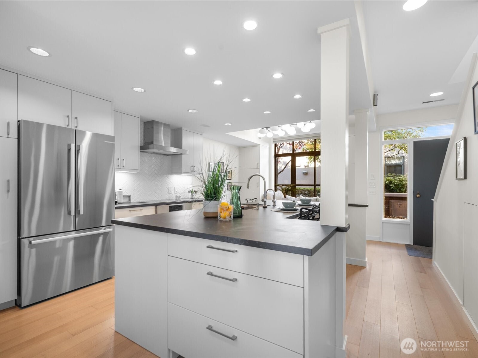 88 Virginia Street, Unit 3 Seattle, WA 98121 - Photo 11 of 40 a kitchen with stainless steel appliances granite countertop a refrigerator and a sink
