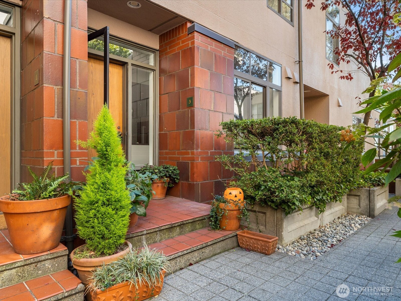 88 Virginia Street, Unit 3 Seattle, WA 98121 - Photo 2 of 40 a house with potted plants in front of it