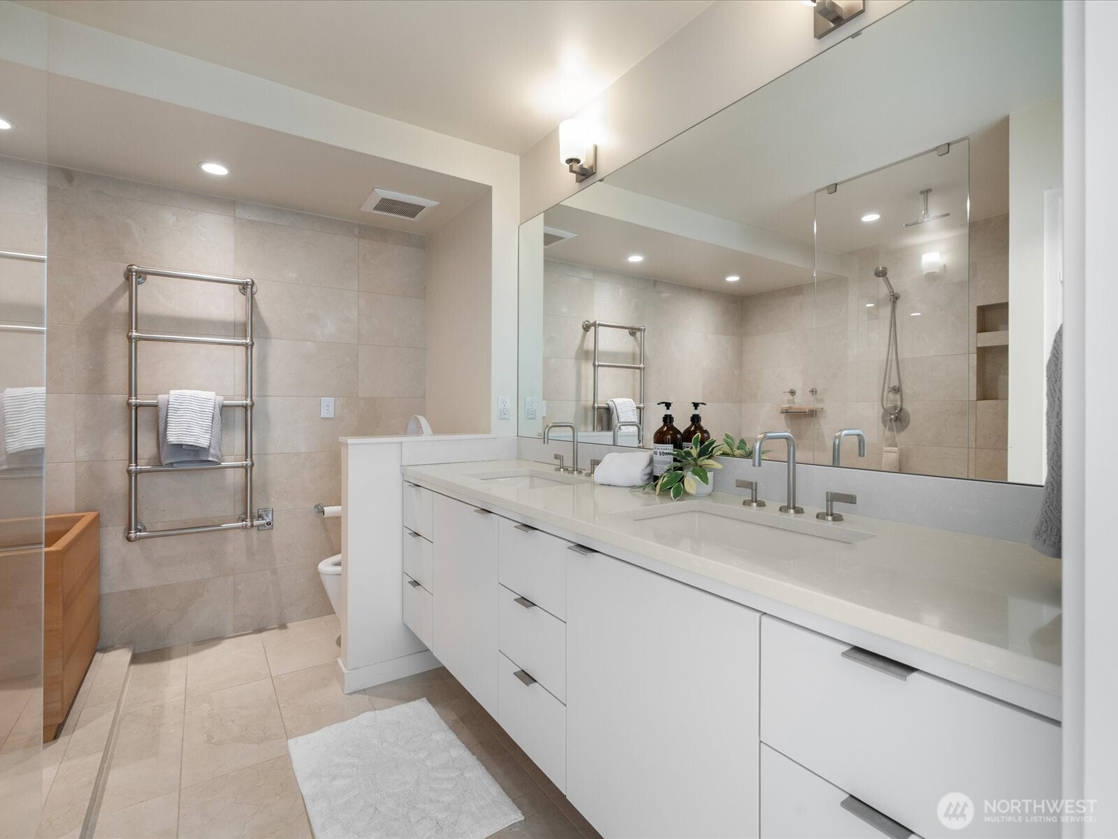 88 Virginia Street, Unit 3 Seattle, WA 98121 - Photo 22 of 40 a bathroom with a double vanity sink mirror and shower
