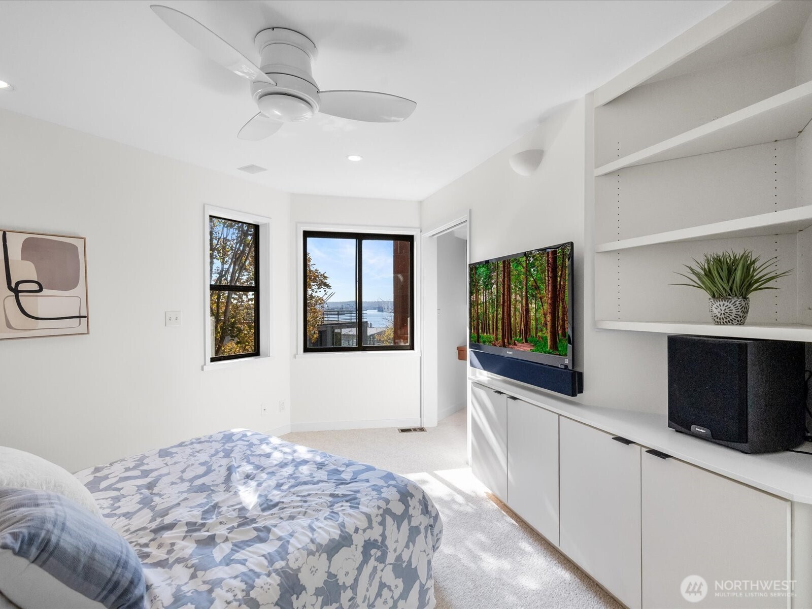 88 Virginia Street, Unit 3 Seattle, WA 98121 - Photo 24 of 40 a bedroom with a bed and a flat screen tv