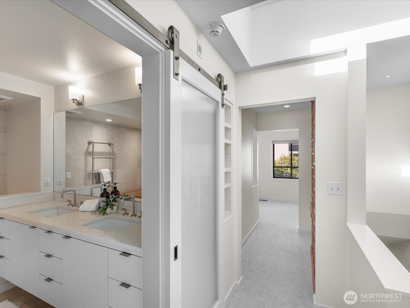 88 Virginia Street, Unit 3 Seattle, WA 98121 - Photo 29 of 40 a bathroom with a double vanity sink and mirror