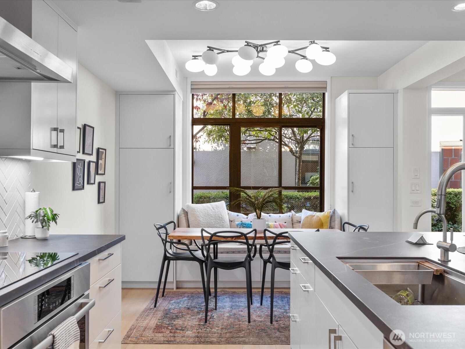 88 Virginia Street, Unit 3 Seattle, WA 98121 - Photo 8 of 40 a kitchen with a table chairs stove and cabinets