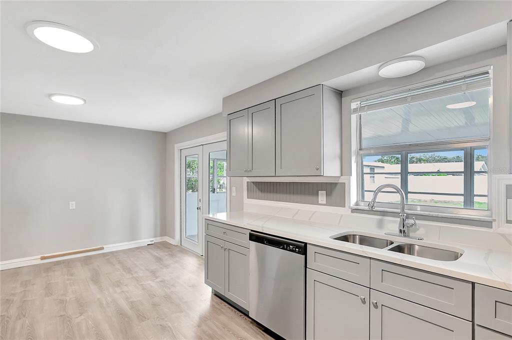 5900 Beech Street Zephyrhills, FL 33542 - Photo 17 of 37 a kitchen with a sink window and cabinets