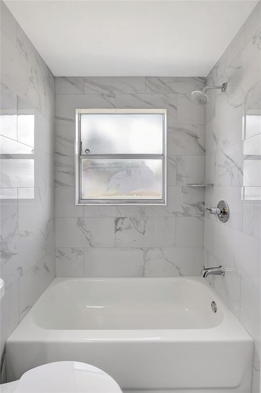 5900 Beech Street Zephyrhills, FL 33542 - Photo 29 of 37 a bathroom with a bathtub and a shower