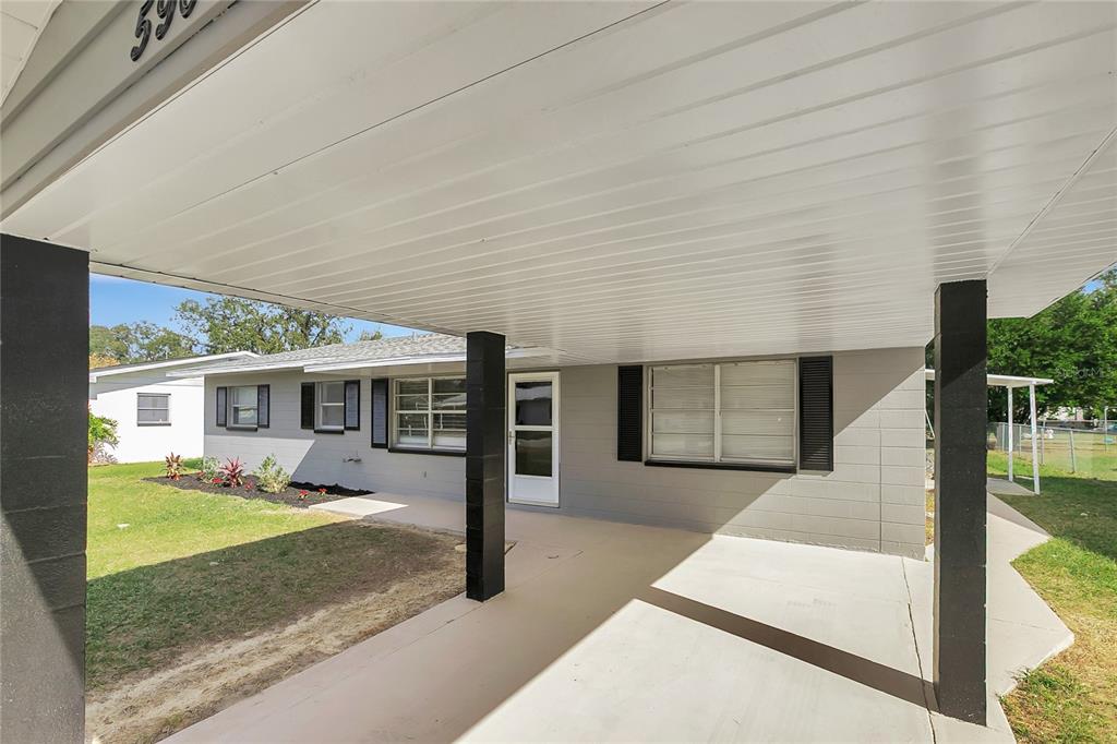 5900 Beech Street Zephyrhills, FL 33542 - Photo 5 of 37 a front view of a house with yard outdoor seating and garage