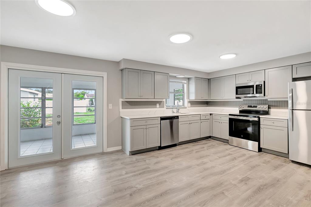 5900 Beech Street Zephyrhills, FL 33542 - Photo 10 of 37 a kitchen with a white cabinets and white appliances