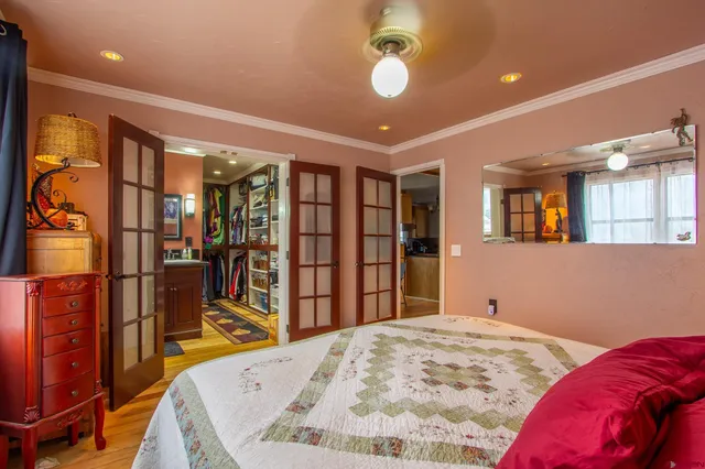 a bed room with a bed and a flat screen tv