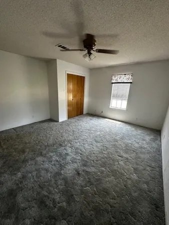 an empty room with a empty space and windows