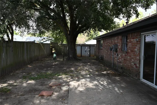 a backyard of a house with plants and trees