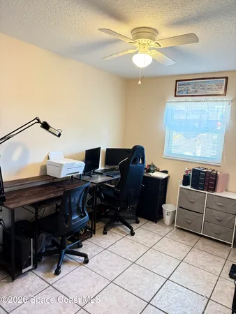 a living room with furniture and a piano