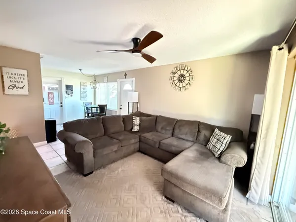 a living room with couches and a large window