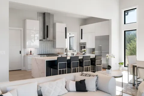 a kitchen with a sink a stove and cabinets