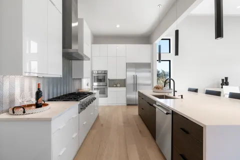 a kitchen with a sink stove and cabinets