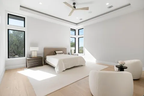 a spacious bedroom with a bed and couch