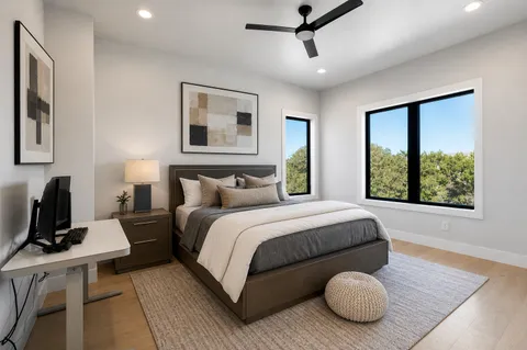 a large bed sitting in a bedroom next to a window