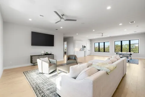 a large bed sitting in a bedroom next to a window