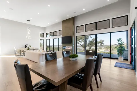 a living room with furniture a flat screen tv and a large window