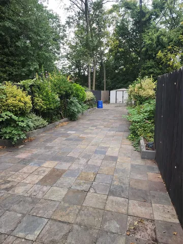 a view of a yard with plants and a trees