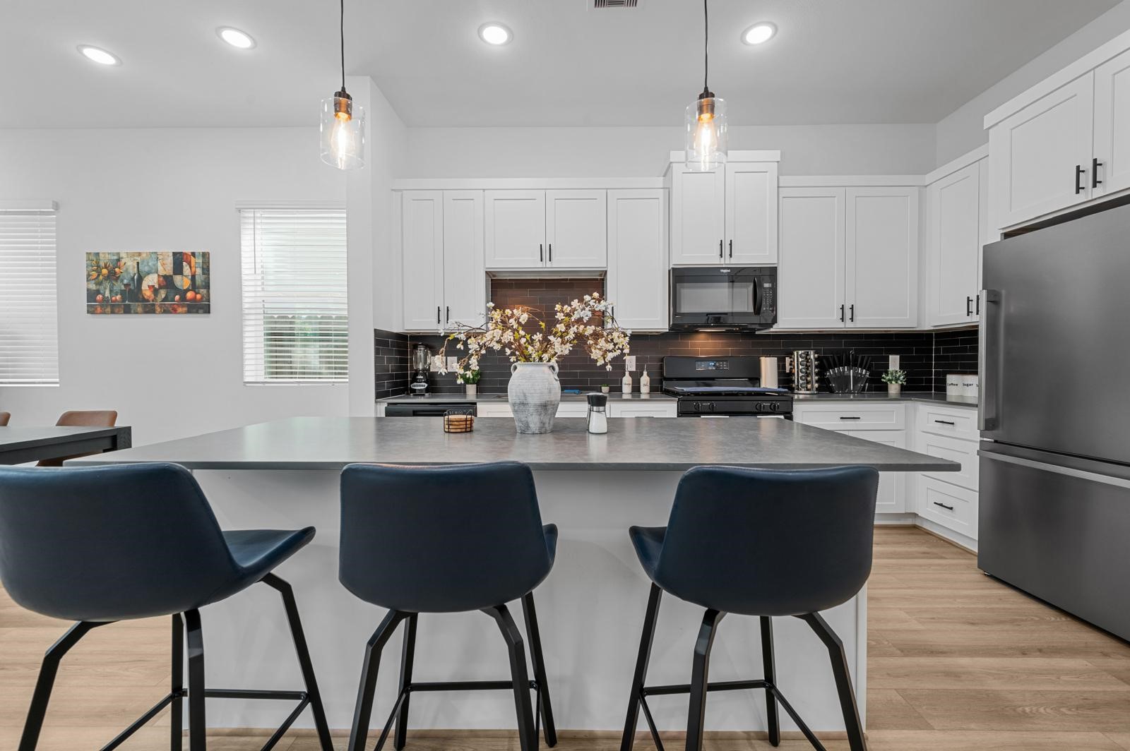 4201 Stassen Street Houston, TX 77051 - Photo 16 of 32 a kitchen with stainless steel appliances granite countertop a dining table chairs microwave and sink