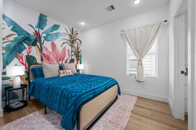 a bed sitting in a bedroom next to a window