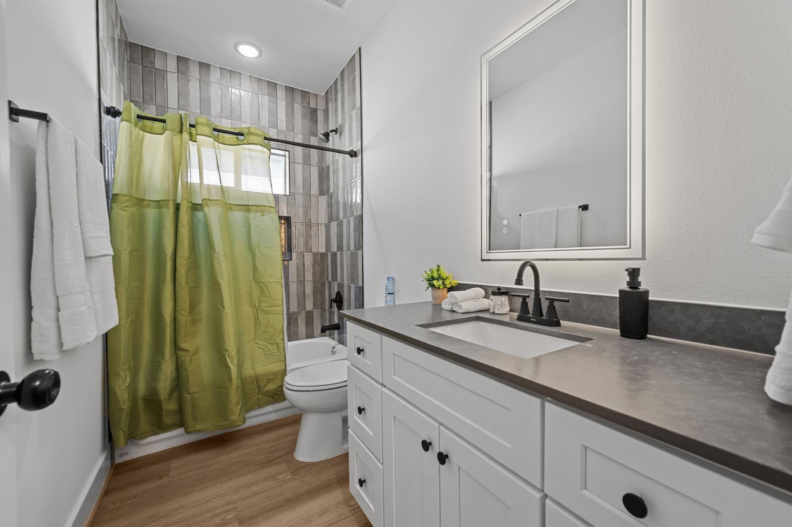 4201 Stassen Street Houston, TX 77051 - Photo 28 of 32 a bathroom with a granite countertop sink toilet and shower