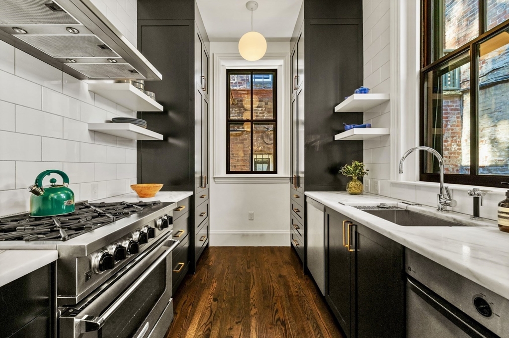 a kitchen with a sink stove and cabinets