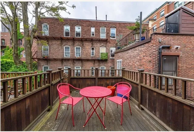 a balcony with table and chairs