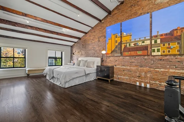 a spacious bedroom with a bed and a table