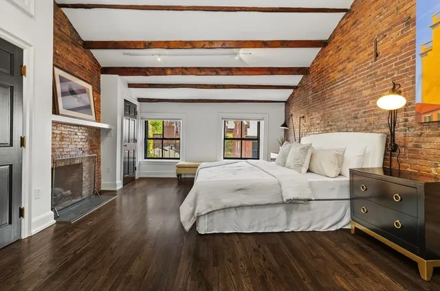 a spacious bedroom with a bed and a fireplace