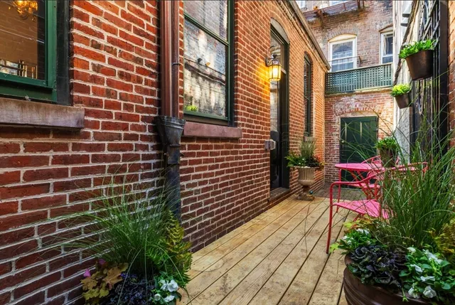 a view of a patio with a table and chairs and potted plants