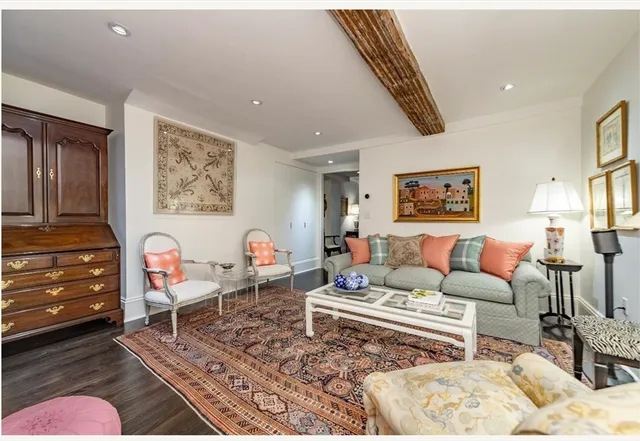 a living room with furniture and a baby crib