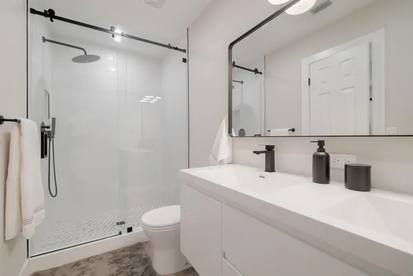 a bathroom with a toilet sink and shower