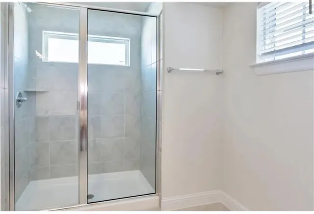 a bathroom with a glass shower door