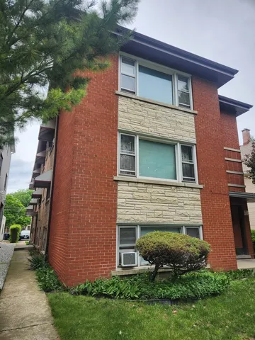a brick building with a yard in front of it